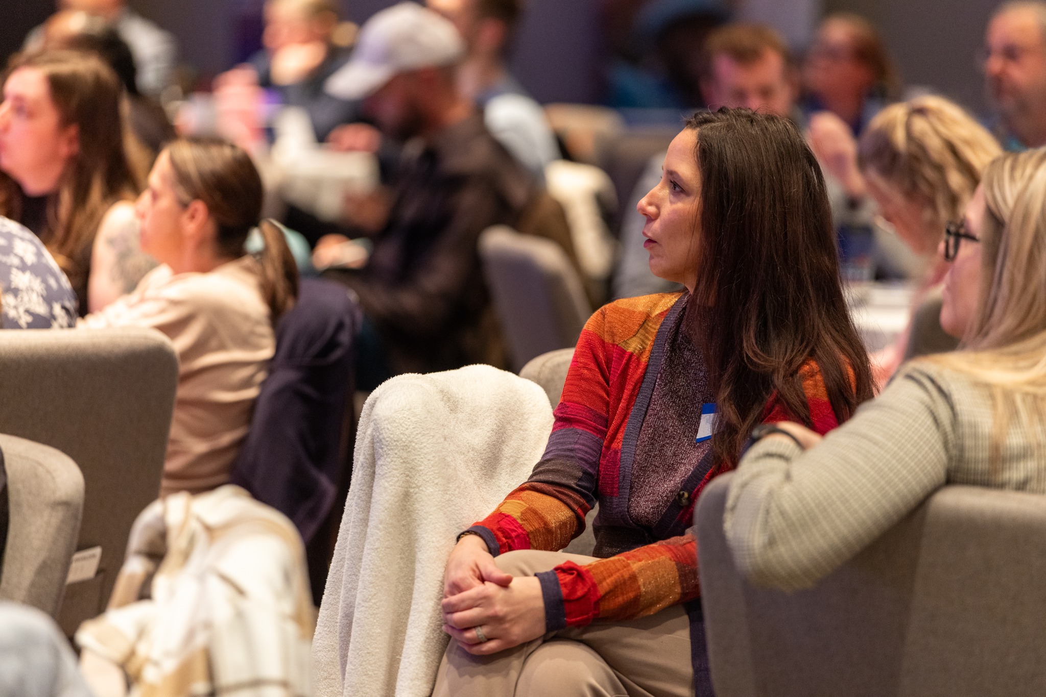 Audience members listening to a presentation