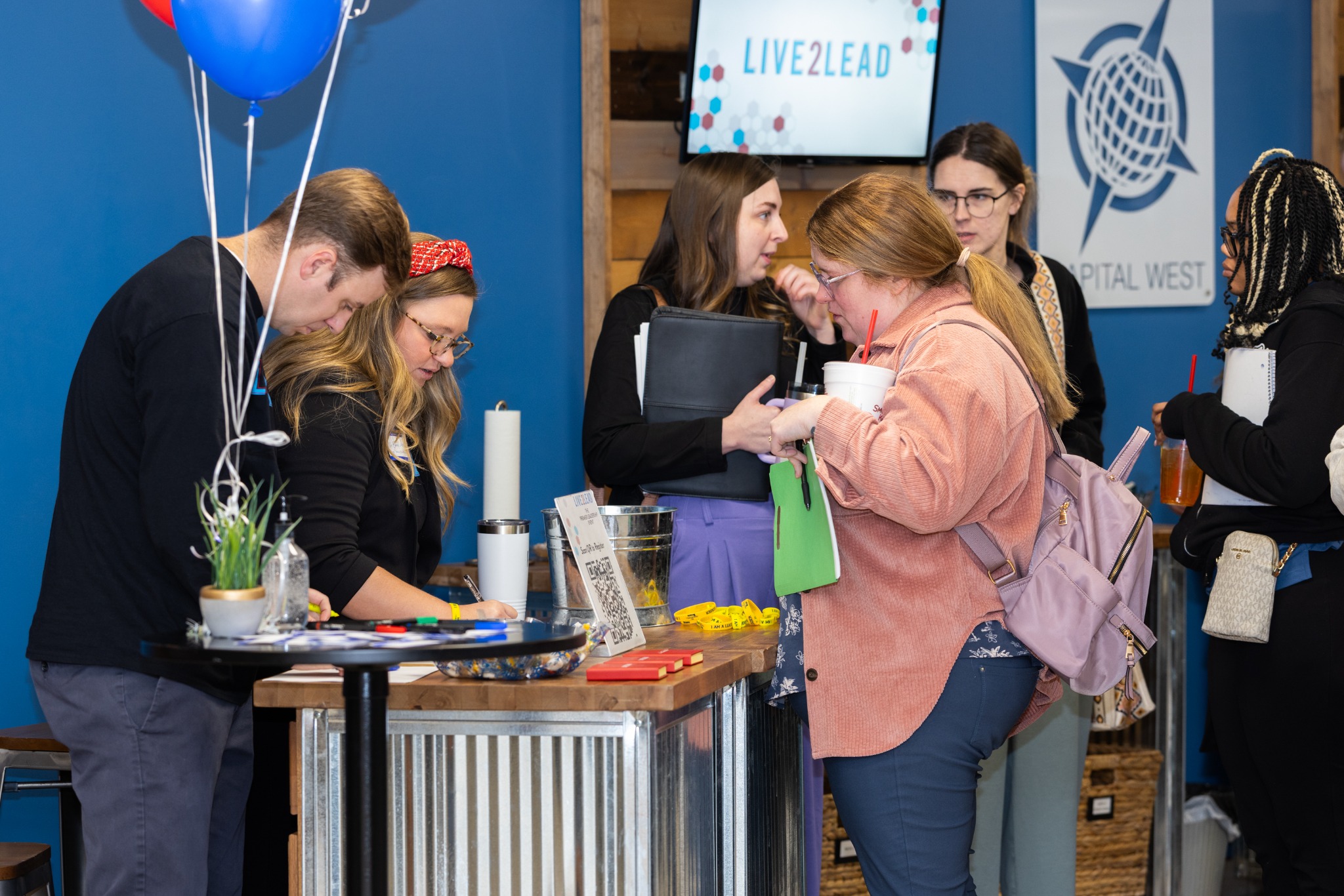 Guests checking in at the Live2Lead registration table