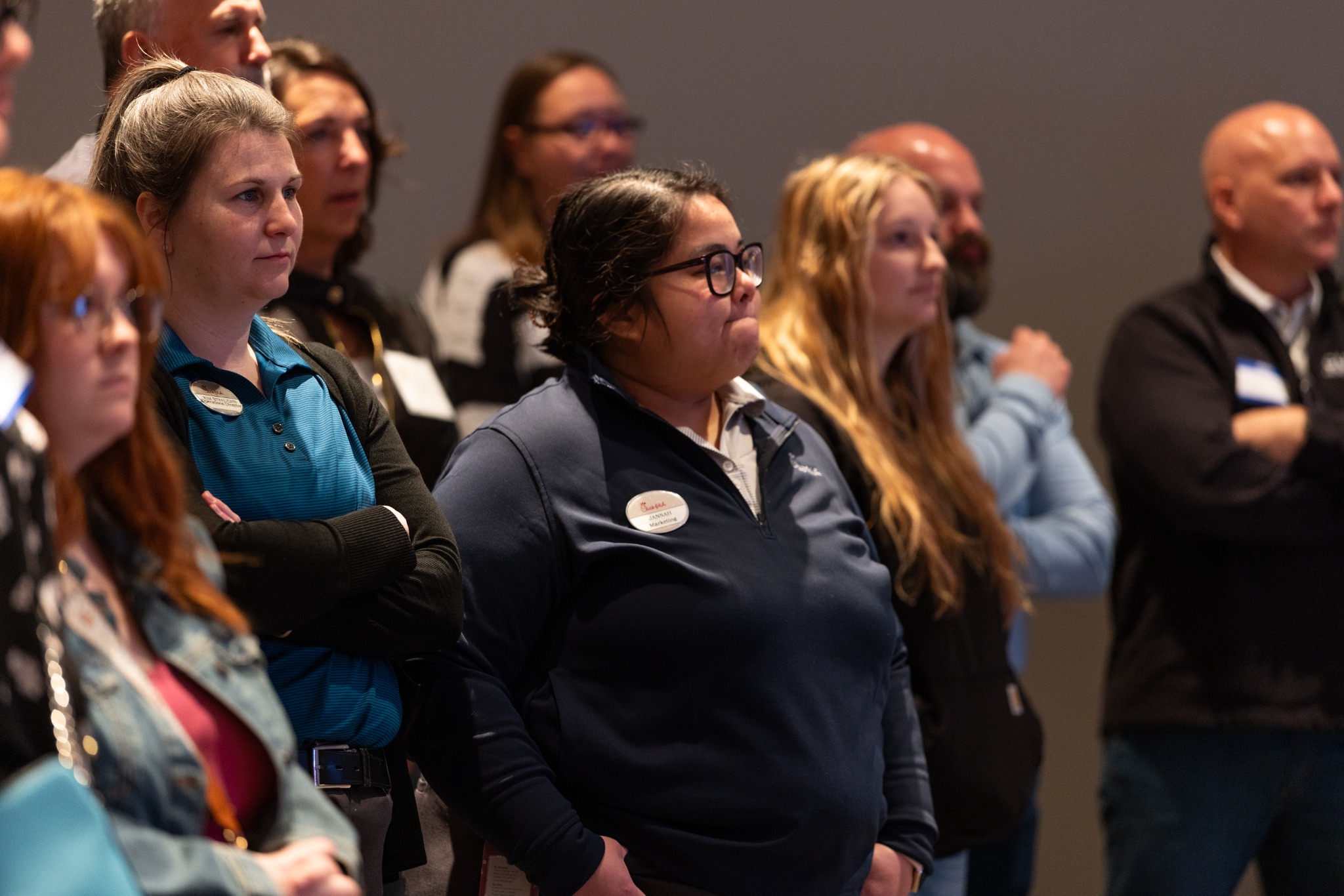 Audience members focused on a presentation