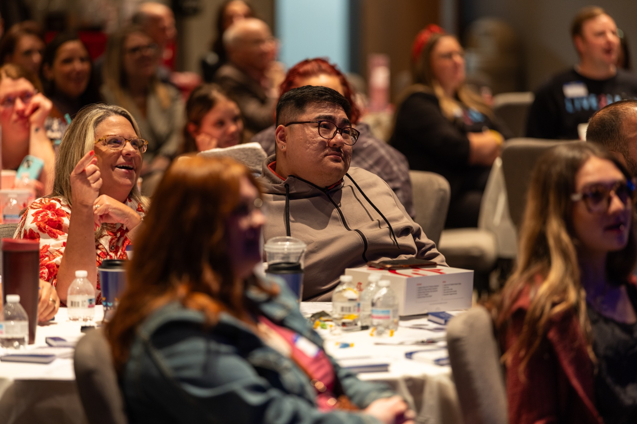 Attendees responding to a presentation
